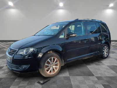 the blue van is parked on a checkered floor in a garage