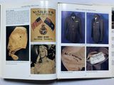an open book with pictures of military uniforms on it
