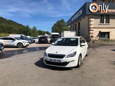 a white car parked in front of a building in a parking lot