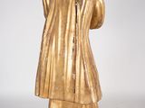 statue of a man in a gold coat and a black hat