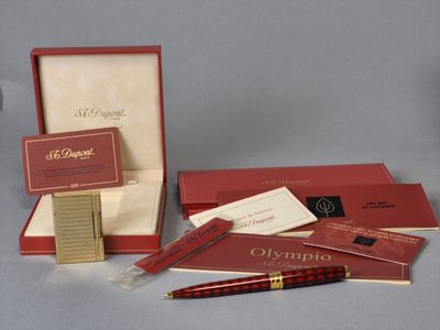a red box with a pen and some other items in it