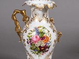 pair of antique porcelain vases decorated with flowers on a gray background