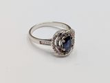 an image of a blue sapphire and diamond ring on a white surface