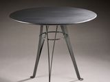an image of a round table with a metal base and a black top