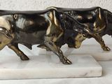 statue of a bull and a bull on a marble base