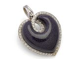 a close up of a heart shaped pendant on a white background