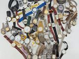 many different types of watches arranged in a heart shape