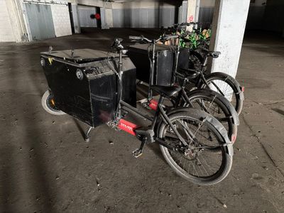 two bikes parked next to each other in a parking garage