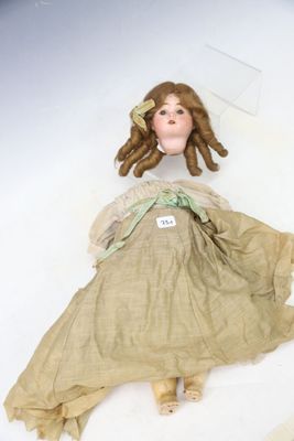 a doll that is laying down on the ground