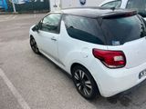 a small white car parked in a parking lot