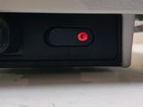 a close up view of a laptop with a red button