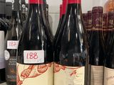 several bottles of wine are lined up on a counter