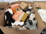 a cardboard box full of shoes and other items