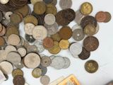 a pile of coins on a table next to a pair of scissors