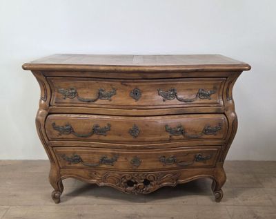 an antique chest of drawers with a marble top on a wooden floor