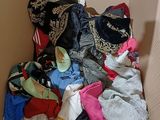 a cardboard box filled with clothes and a hat
