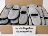 many pairs of shoes in a box with a sign on it