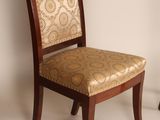 pair of wooden chairs with upholstered upholstered back and upholstered upholstered seat
