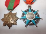 two medals are sitting on a table with ribbons around them