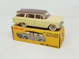 yellow toy car sitting on top of a yellow box on a white surface
