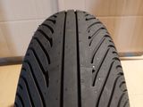 a close up of a motorcycle tire on a wooden floor