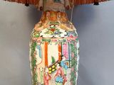 a lamp that is sitting on a table with a lamp shade on it