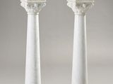 pair of white marble pedestals on a gray background