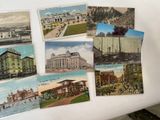 many old postcards of different buildings on the table