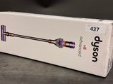 the box of the dysonon cordless vacuum is open on the table