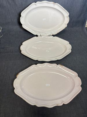 three empty plates on a table with a glass of wine