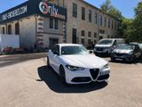 a white car that is parked in front of a building
