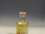 a small bottle of tequila sitting on a counter