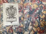 an old book with a picture of a coat of arms on it