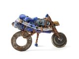 a toy motorcycle made out of a tire with a bag on the back of it
