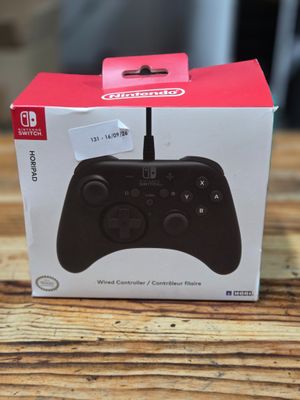 the box of a nintendo wii controller sitting on top of a wooden table