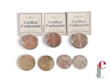 four different types of coins are shown on a white surface