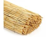 a pile of bamboo sticks on a white surface