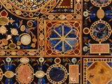 a close up of a wall with a clock on it ' s side