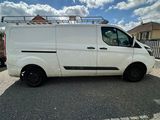 a white van parked in a parking lot with a sky background