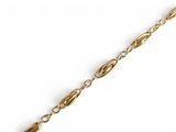 a close up of a gold chain on a white background