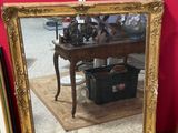 a mirror and a pair of shoes on the floor