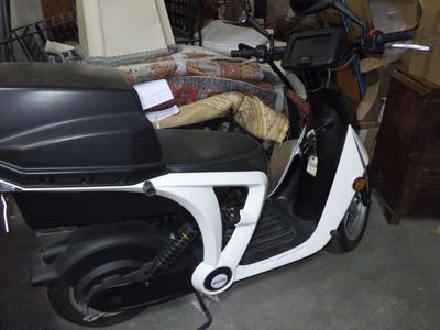 a motor scooter that is parked in a garage