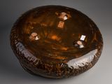 a brown vase that is sitting on a table