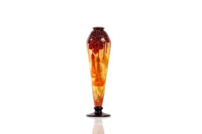 a red and yellow vase sitting on a white surface