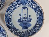 three blue and white plates with flowers on them
