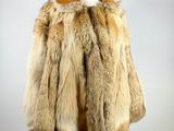 a close up of a fur coat on a mannequin stand
