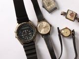 many different types of watches and bracelets laid out on a table