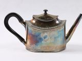 a silver tea pot with a blue and purple design