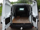 a white van with its doors open in a parking lot