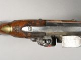 an old gun with a wooden handle on a white surface